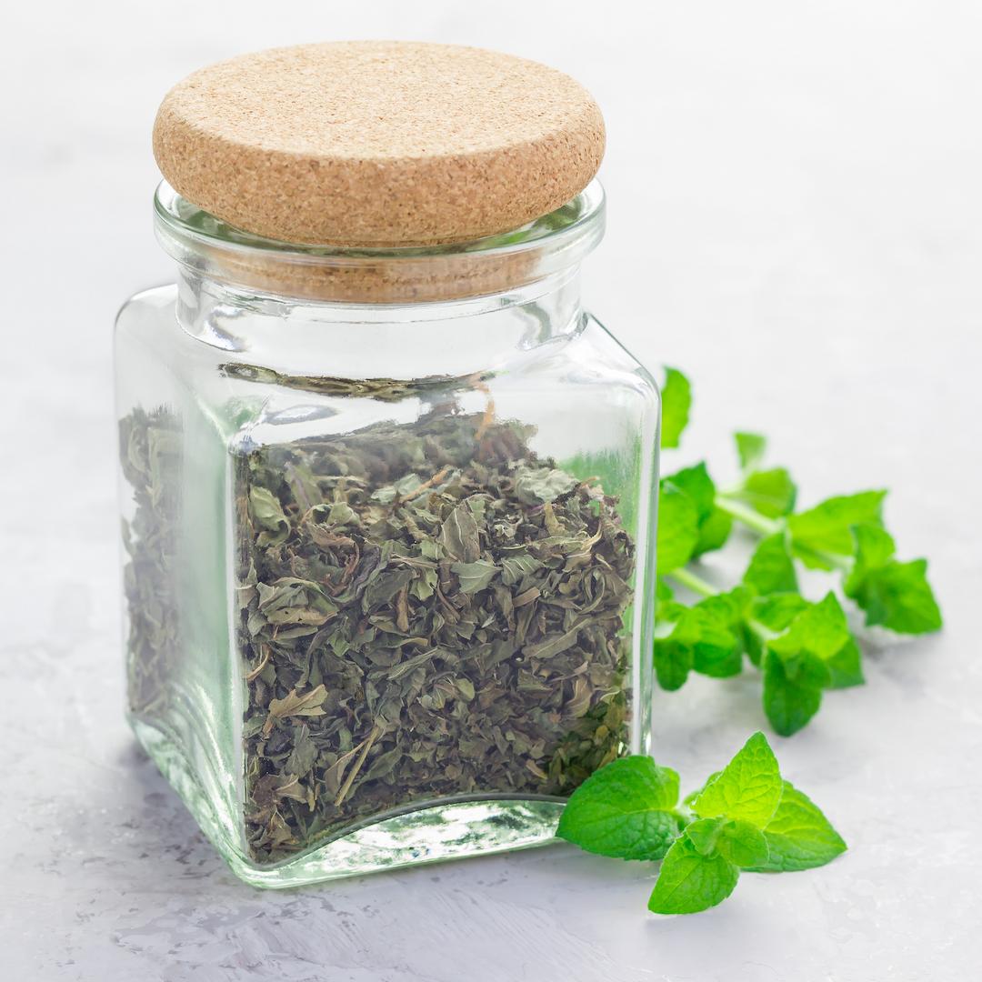 A small jar of peppermint tea leaves