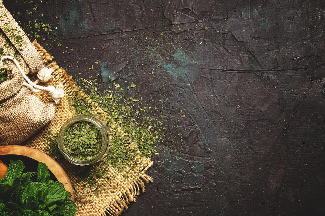 Peppermint tea leaves on a stone background